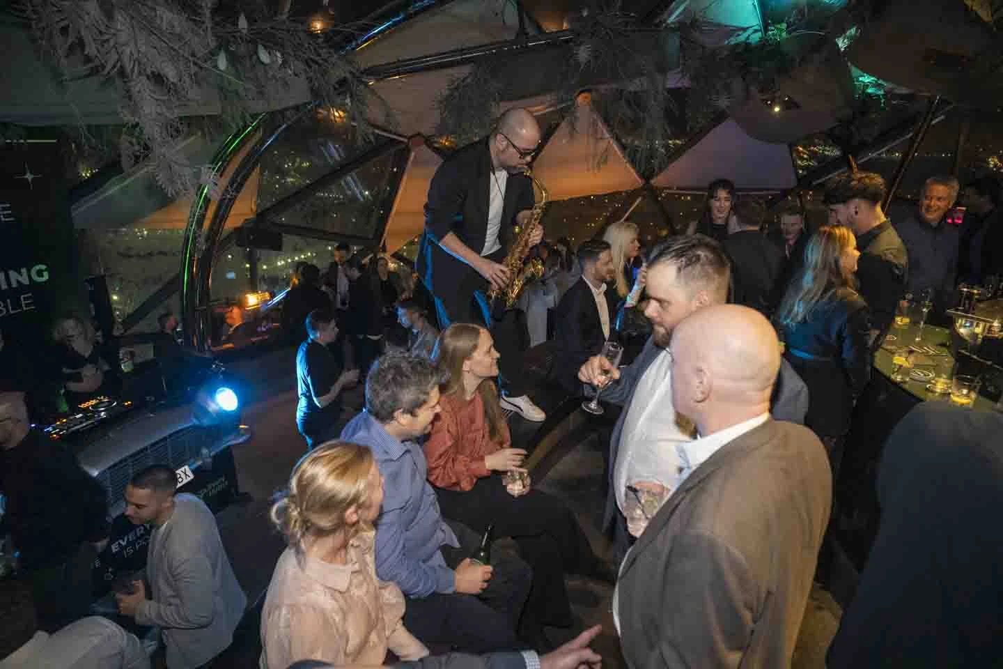 Guests and a saxophonist at the Altitude Barcelona evening