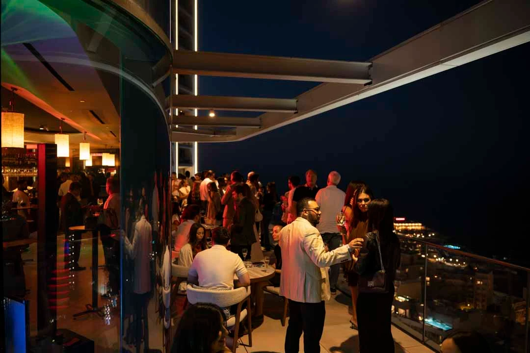 Guests gathered on the Radio Rooftop terrace at night