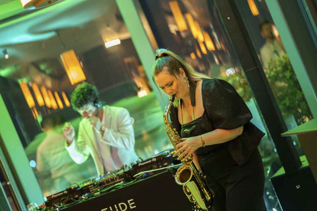 Live saxophone performance among guests at the Malta Altitude evening