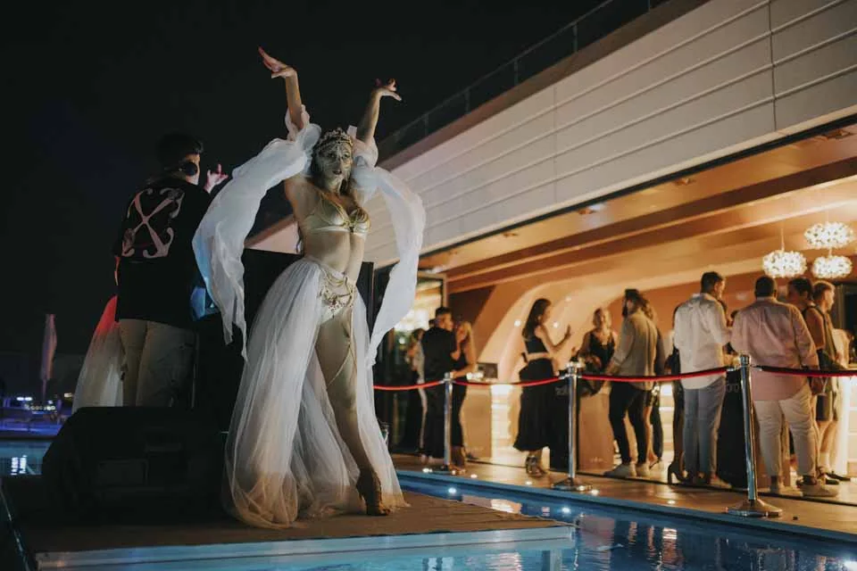 A performer beside the rooftop pool · Noyane · September 2024