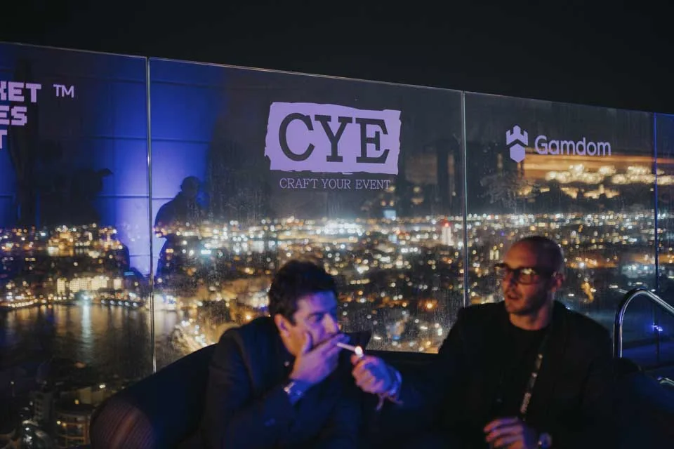 Guests connecting beside the city skyline · Noyane · November 2024