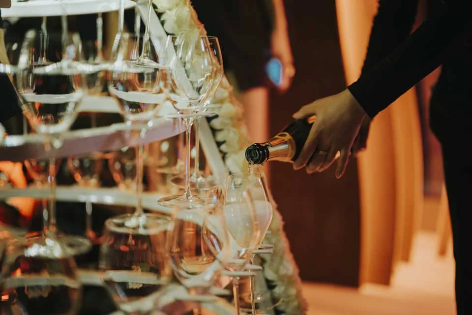 Champagne poured into a glass tower · Mamachi, St Julian’s