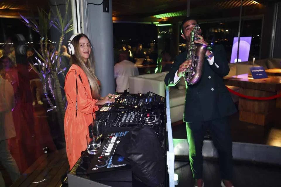 The DJ and saxophonist performing · A Lisbon evening