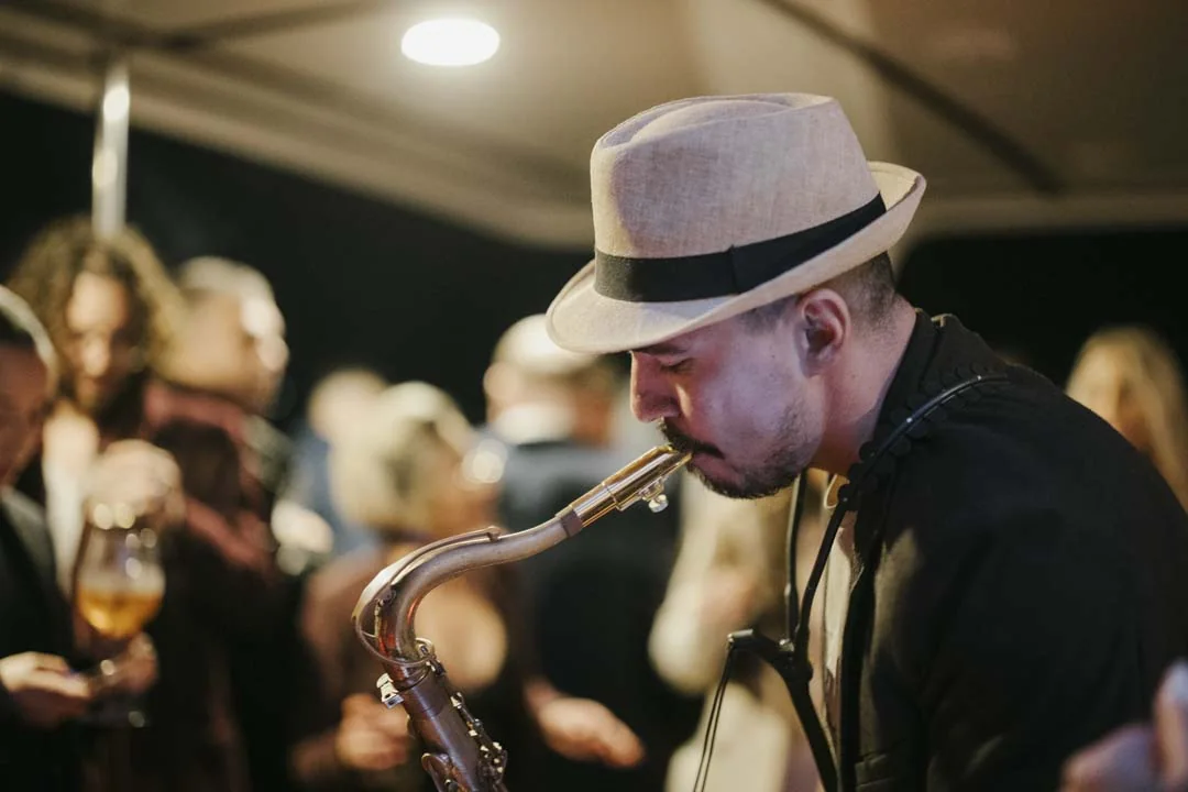The saxophonist performing onboard · AFLOAT — Exclusive Networking at Sea