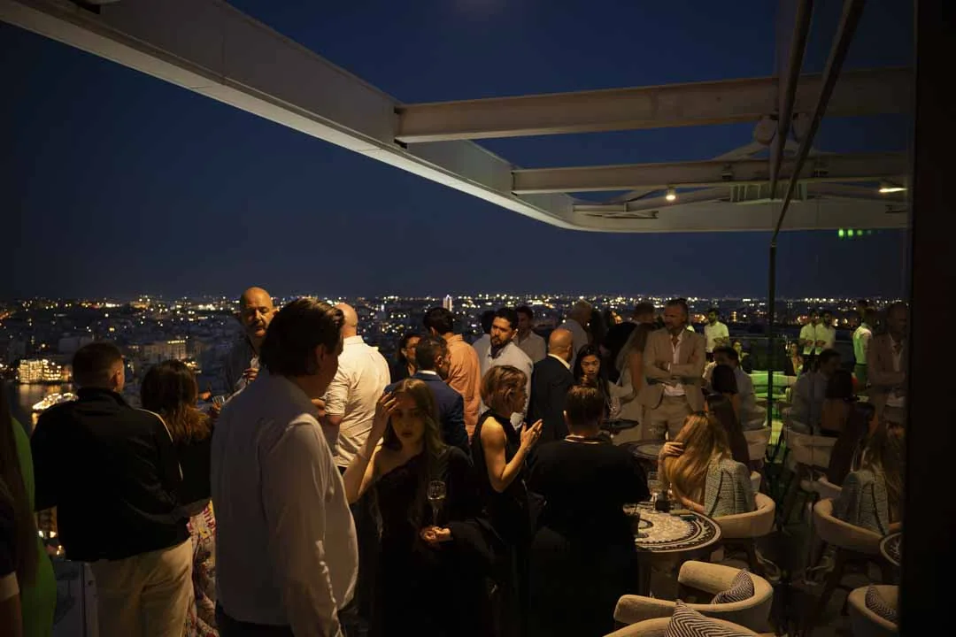 Guests on the Radio Rooftop terrace · Above the island